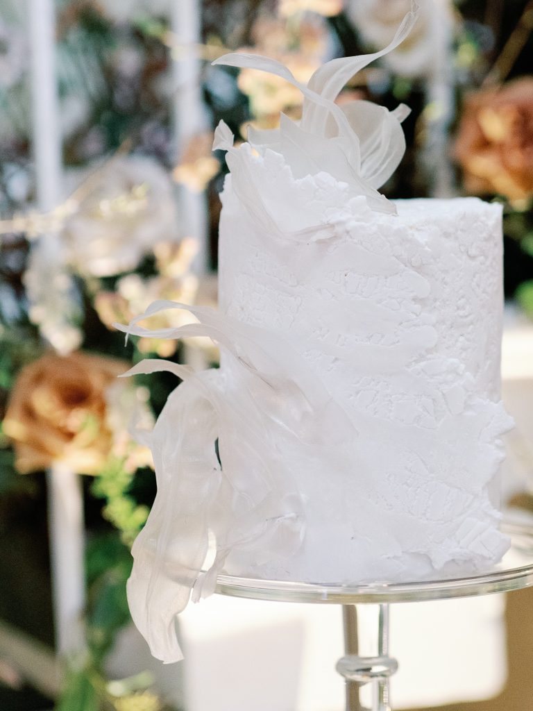 Elegant, artistic, modern wedding cake in white, created by Where The Ribbon Ends.