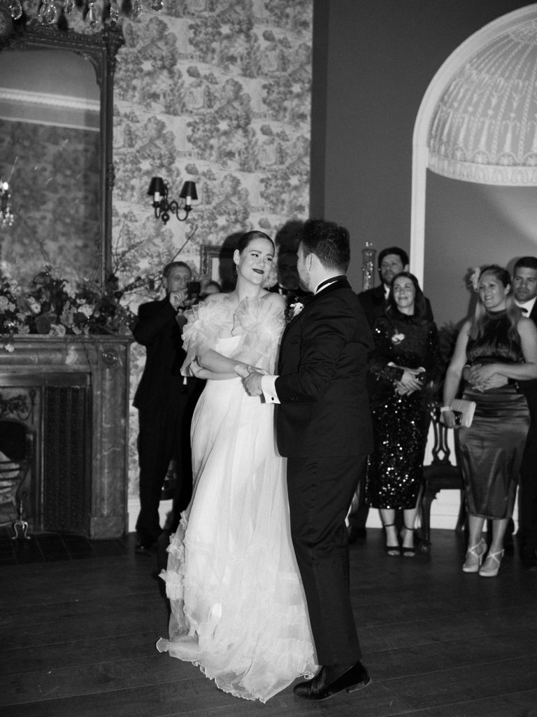 Else and Rory on the dancefloor dancing together and smiling.